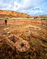 The Great Kiva at Chetro Ketl at Chaco Culture National Historic Park is ceremonial , round, built of stone, sacred, a place of worship, and shows stone working skills.