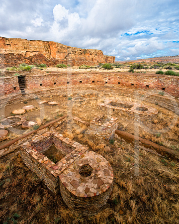 The Great Kiva at Chetro Ketl at Chaco Culture National Historic Park is ceremonial , round, built of stone, sacred, a place of worship, and shows stone working skills.