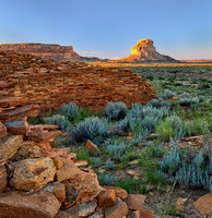 Una Vida Indian Ruins Remain In Shadow At The Edge Of Dawn As Rays Of The Rising Sun Strike Fajada Butte At Chaco Canyon  In This Dramatic Commercial Landscape Photograph By Brian Buckner Photography.