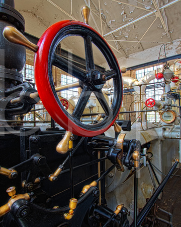 At Shreveport Water Works Museum, also known as McNeill Street Pumping Station, a large red valve wheel with brass handles controls the flow of steam in the water treatment facility in Shreveport, Lou