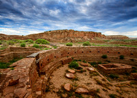 The Great Kiva Of Chetro Ketl Rests Undisturbed As An Ominous Sky Dawns  At Chaco Culture National Historic Park in this commercial landscape photograph by Brian Buckner Photography, Shreveport.