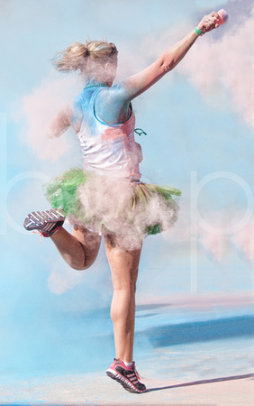 A Female 5K Marathon Runner With A Ballerina's Tutu Costume Celebrates The Finish Of The Race With Some Powder Paint in this artistic event photograph by Brian Buckner Photography, Shreveport, Louisia