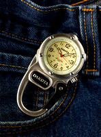 A Dakota Mini Clip Micro Light Watch is shown resting by the pocket of a pair of blue jeans advertising it's use in this commercial product advertising photograph by Brian Buckner Photography.