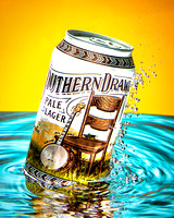 A can of Southern Drawl beer produced by the Great Raft Brewing Company is shown exploding out of the water in this commercial product advertising photograph by Brian Buckner Photography, Shreveport.