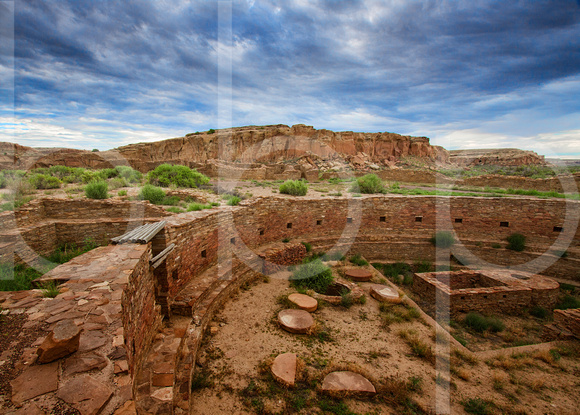 The Great Kiva Of Chetro Ketl Rests Undisturbed As An Ominous Sky Dawns  At Chaco Culture National Historic Park in this commercial landscape photograph by Brian Buckner Photography, Shreveport.