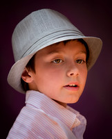 A Young Boy Is Posed Wearing A Hat And Then Photographed Under Very Soft Light in this professional commercial child portrait photograph by Brian Buckner Photography, Shreveport, Louisiana.