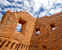Three windows at Pueblo Bonito Indian Ruin at Chaco Canyon under a blue sky in this commercial architectural photograph by brian buckner photography, shreveport, louisiana.
