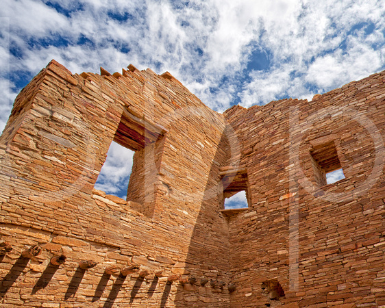 Three windows at Pueblo Bonito Indian Ruin at Chaco Canyon under a blue sky in this commercial architectural photograph by brian buckner photography, shreveport, louisiana.