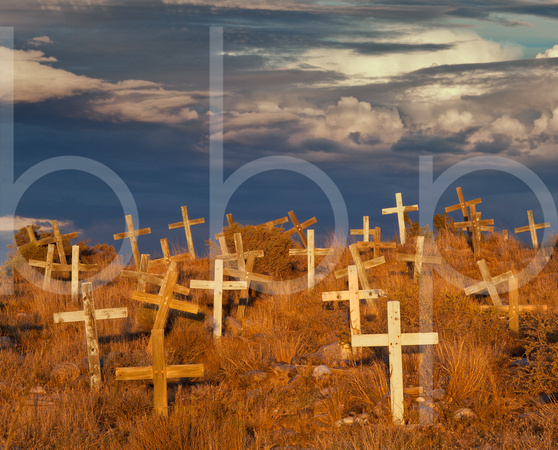 Beautiful late afternoon light from the sun shines on weathered wooden cross's at an old mission cemetery in this evocative commercial landscape photograph by Brian Buckner Photography, Shreveport.