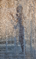 A Silhouetted Child Plays And Splashes In A Cities Water Park Fountain Enjoying Summertime Fun In This Commercial Artistic Photograph Of A City Scene By Brian Buckner Photography, Shreveport.