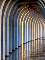 Pilings of a concrete bridge on Cross Lake in Shreveport, Louisiana  are shown repeating themselves across the lake in this commercial architectural photograph by brian buckner photography, shreveport