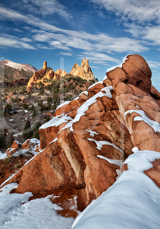 Fresh Late Winter Snow Laces Red Rock Sandstone Formations, Which Point Toward Distant Fin And Spire Shaped Peaks in this commercial landscape photograph by Brian Buckner Photography, Shreveport.
