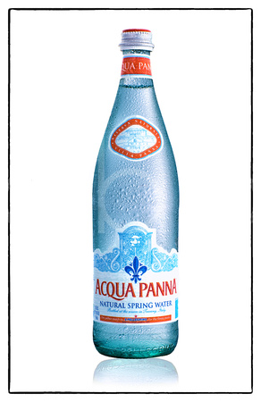 Acqua Panna Italian Natural Spring Water is photographed by brian buckner photography in this commercial product photograph showing it chilled in it's classic blue bottle covered with condensation.