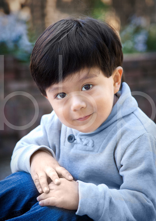 A handsome young boy poses outdoors under soft light in this striking character study or child portrait by Brian Buckner Phtography, Shreveport, Louisiana.