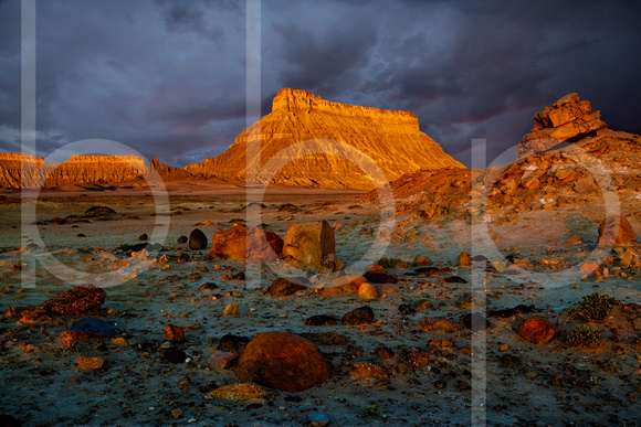 Factory Butte is located near capitol Reef National Park and is shown with dawn light making it orange in this commercial landscape photograph by Brian Buckner Photography, Shreveport, Louisiana.