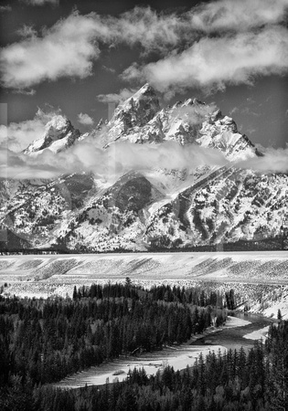 Wispy White Clouds Of Winter Accent The Snow Covered Peak Of The Grand Teton In The Rocky Mountains In This Commercial Black And White Landscape Photograph By Brian Buckner Photography, Shreveport.